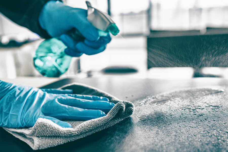 Cleaning gloves cleaning counter with spray